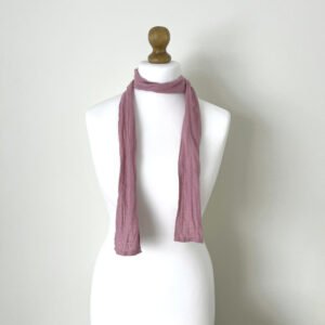 Lilac skinny scarf made of softened linen fabric, displayed on a white mannequin. The scarf is thin, with a simple design.