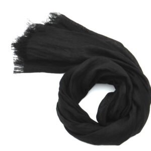 Small black linen scarf with frayed edges, coiled on a white background.