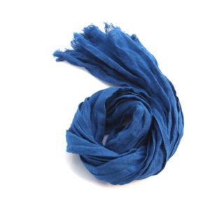 Small royal blue lightweight linen scarf with frayed edges, coiled on a white background.