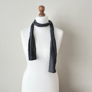 Dark grey skinny scarf made of softened linen fabric, displayed on a white mannequin. The scarf is thin, with a simple design.