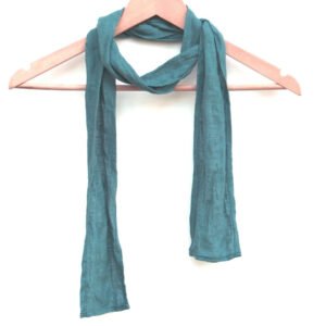 A skinny teal linen scarf hanging on a wooden hanger. The scarf is thin, with a simple design.