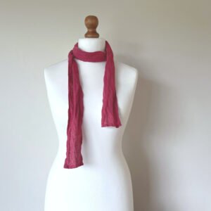 Raspberry pink skinny scarf made of softened linen fabric, displayed on a white mannequin. The scarf is thin, with a simple design.