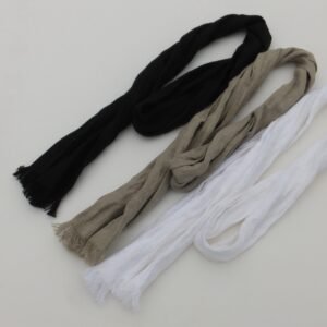 Three skinny scarves in different colours: black, beige, and white. The scarves are made of a soft, woven linen fabric and have fringed edges.