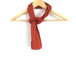 A skinny burnt orange unisex scarf made of softened linen fabric