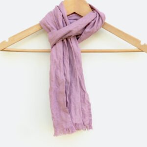 Small lilac linen scarf with frayed edges hanging on a wooden hanger against a white background.