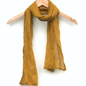 Mustard yellow gauze linen scarf draped on a wooden hanger against a white background.